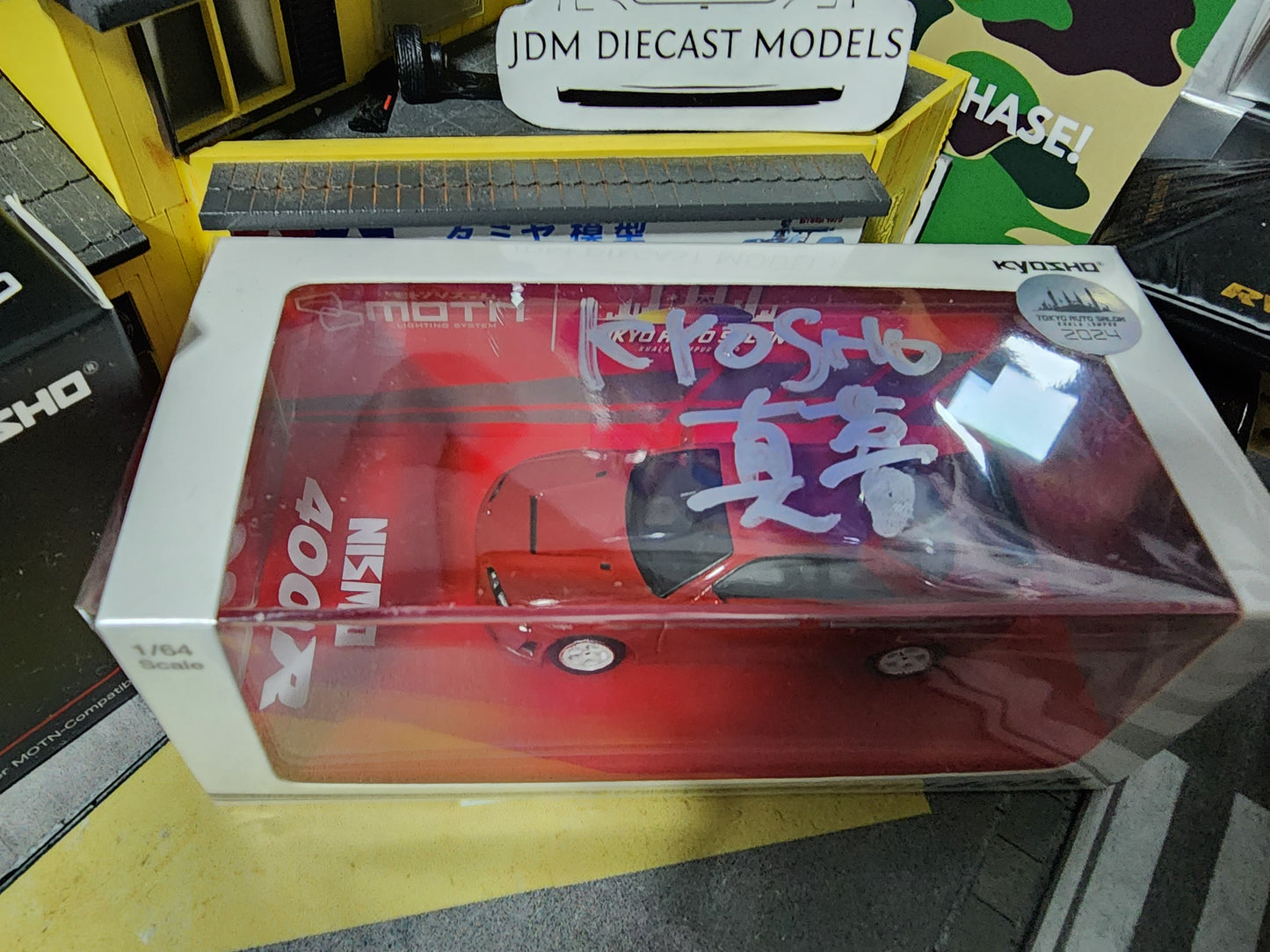 Kyosho Nissan Skyline Nismo 400R Red with MOTN base signed by Masamu San, Designer of MOTN Tech, Kyosho